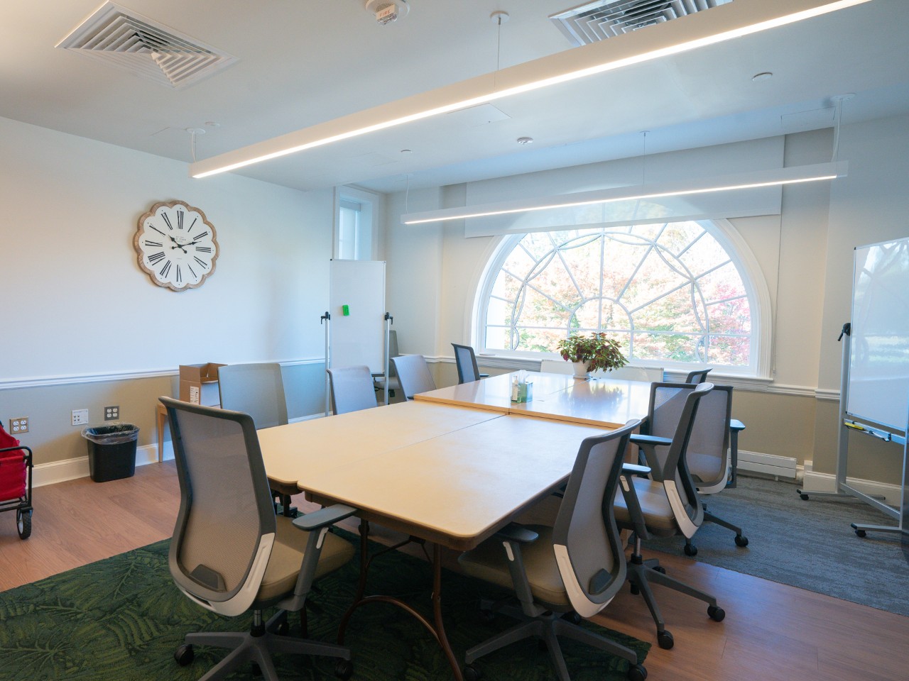 Meeting room with table. four chairs and glass writing board