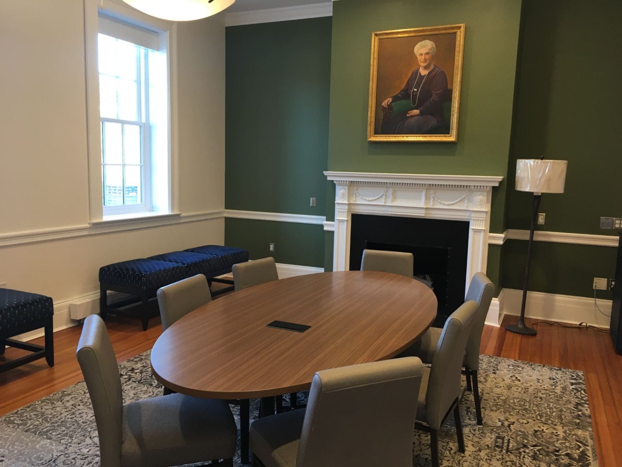 Intimate space with seven chairs around a round table and bench seating along the walls