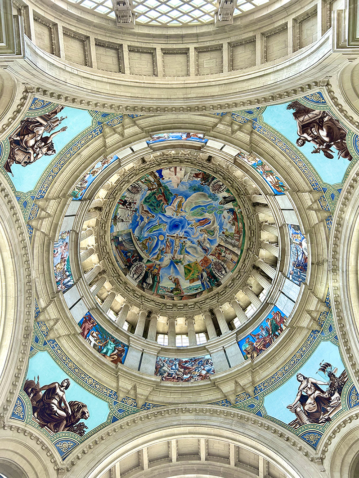 A colorful image with blue hues of the ceiling artwork in Mirador del Palau Nacional