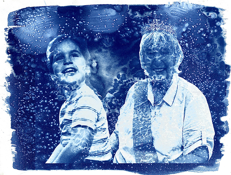 Dark blue and white cyanotype picture of a young girl next to an older woman. There are speckles, splotches, and imperfections over the picture