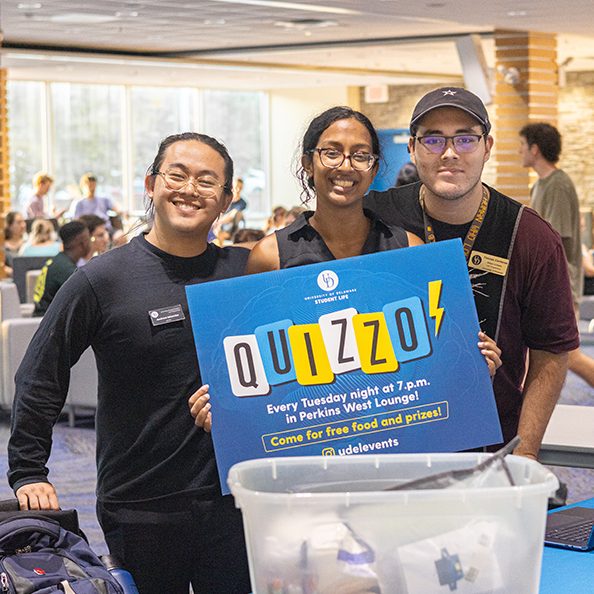 Students holding a Quizzo sign