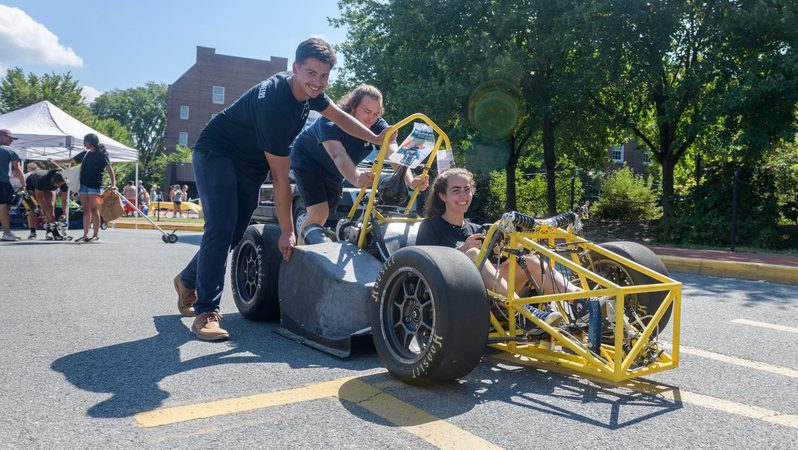 Students demonstrate their Formula SAE car