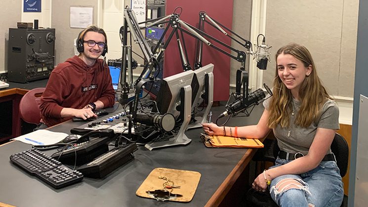 Two student DJs broadcasting from a WVUD studio