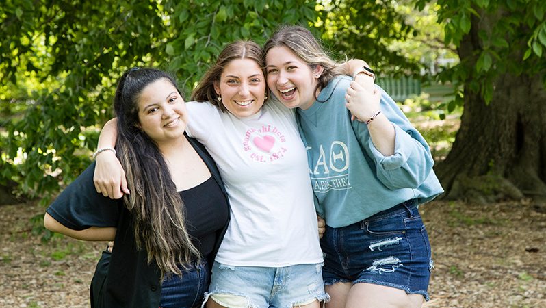Sorority sisters smiling with arms around each other