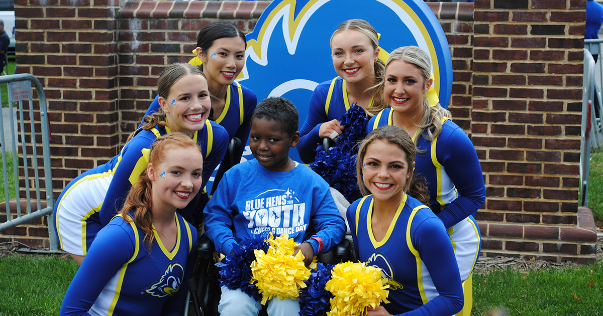 UD students pose with B+Heroes participant
