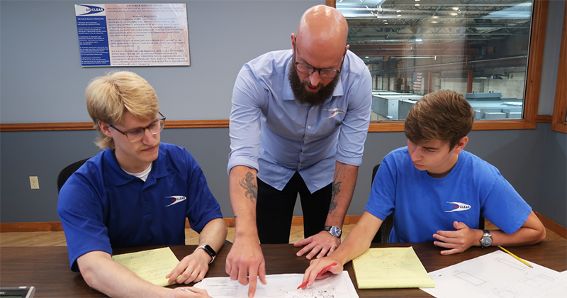 Air Clear employees work together at table