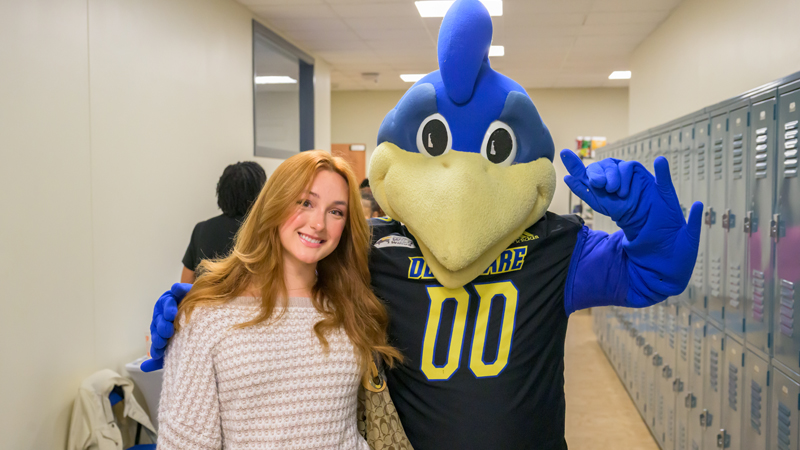 a student poses with YouDee.