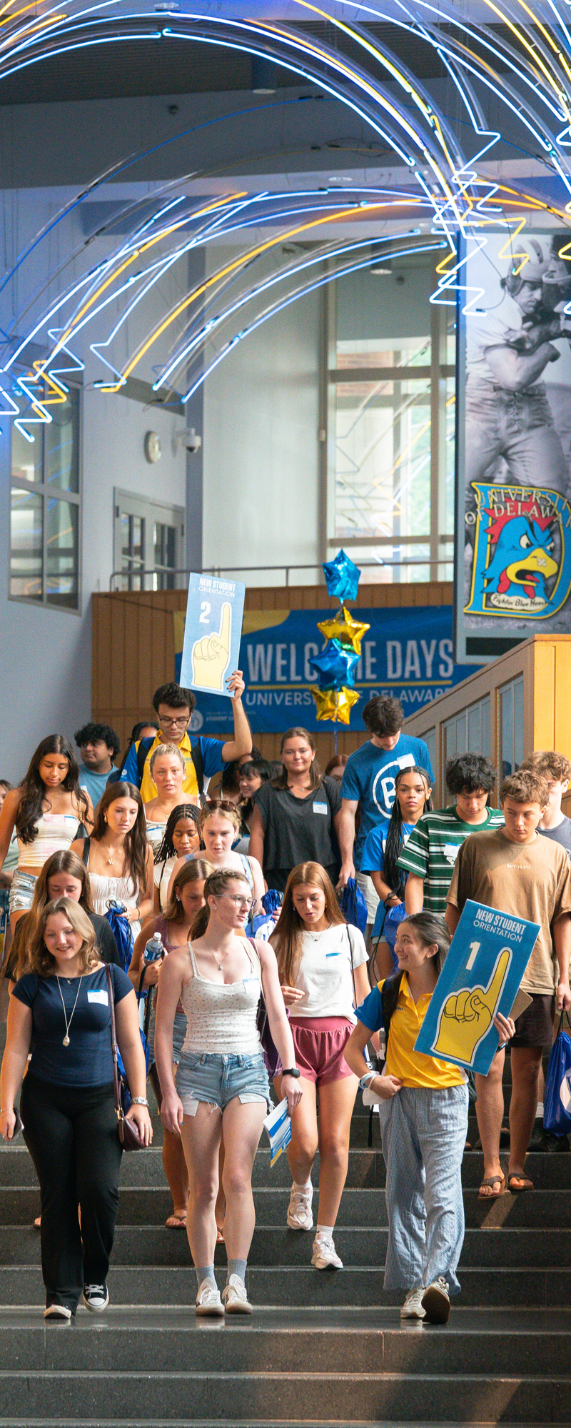 a group of students files down the stairs in Trabant, headed toward New Student Orientation