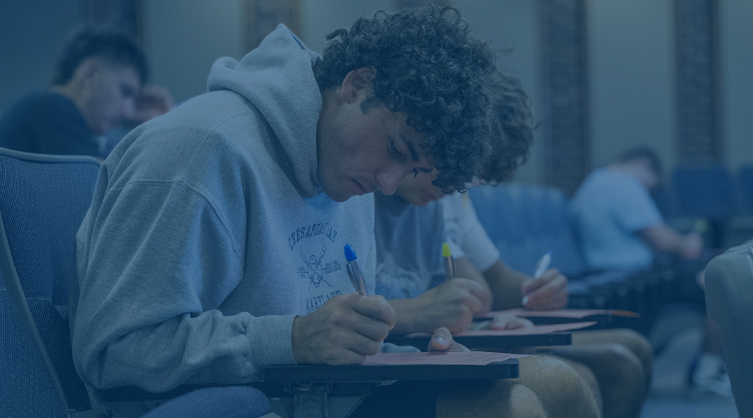 a student works on his desk in a classroom