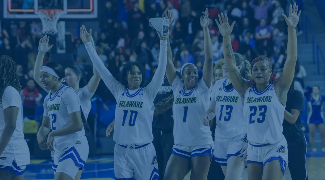 UD women's basketball team celebrates a win