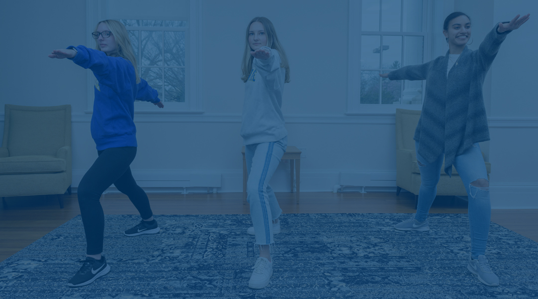 three students participate in yoga at Warner Hall