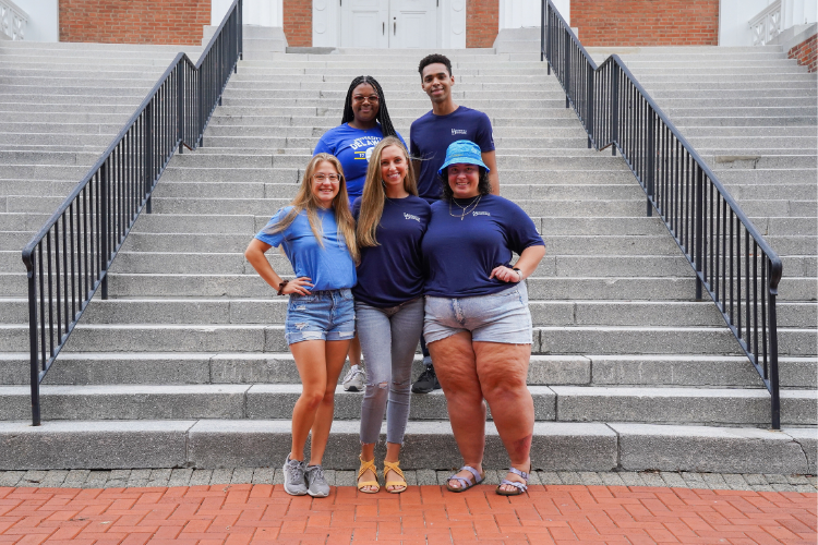RLH graduate assistants standing on the steps of Old College