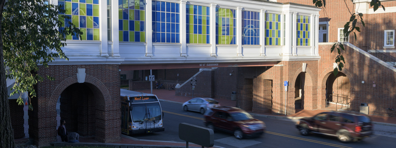 pedestrian overpass walkway from connecting Gore and Smith Halls with a UD bus and other vehicles passing on the street below