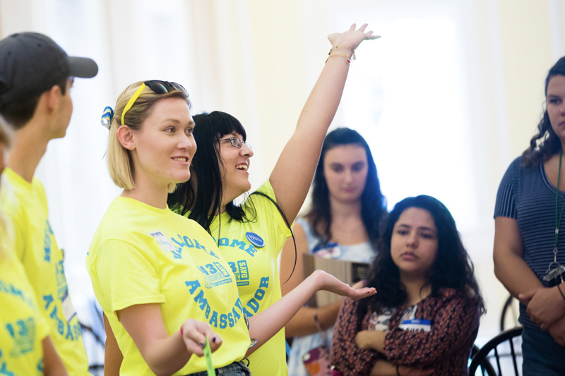 Welcome Ambassadors dressed in bright yellow t-shirts enthusiastically lead activities at a transfer and commuter student meetup