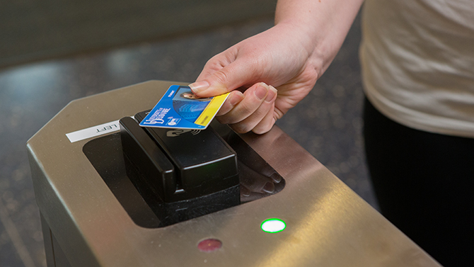 Students Dana Mieras and Kathryn Almon showing the new contactless ID cards at Carpenter Sports.