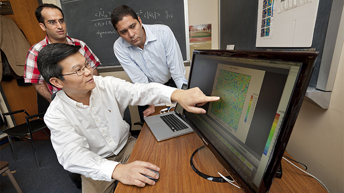 Lian-Ping Wang, Professor of Mechanical Engineering, with several of his students [Charmine Qiu (grey tee shirt), Charles Andersen (red-grey grid shirt), Mingliang Xie (tan striped shirt), Hossein Parishani (red checkered shirt), and Orlando Ayala (light blue checkered shirt)]