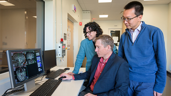 Keith Schneider, assistant professor of Psychological and Brain Sciences; Diane Chugani, a newly-hired tenured faculty at UD and principal research scientist at Nemours who is internationally recognized for her research and leadership in the field of autism; and Shaohui Zhang, assistant research scientist at Nemours, in the fMRI control room of the Center for Biomedical and Brain Imaging (CBBI) at UD. The group is part of an effort to expand the "research and educational collaborations related to autism services, including the creation of an autism focused academic program at UD and a positron emission tomography-magnetic resonance imaging (PET/MRI) suite at Nemours" [UDaily]. - (Evan Krape / University of Delaware)