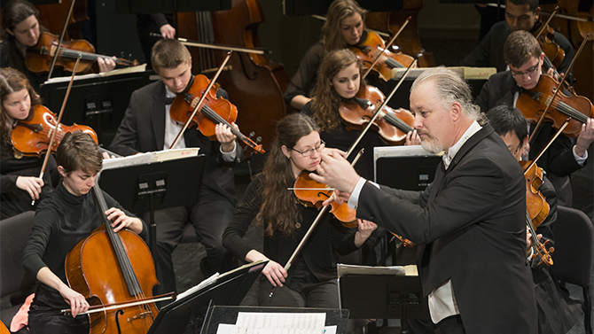 The University of Delaware Symphony Orchestra warms up prior to a performance in Mitchell Hall.