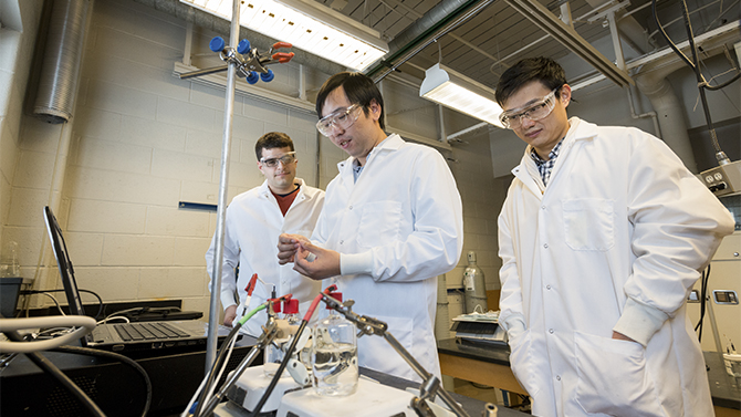 Assistant Professor Feng Jiao and students in his lab in Colburn Laboratory. Professor Jiao is researching methods to turn CO2 (Carbon Dioxide) and CO (Carbon Monoxide) into useable products.