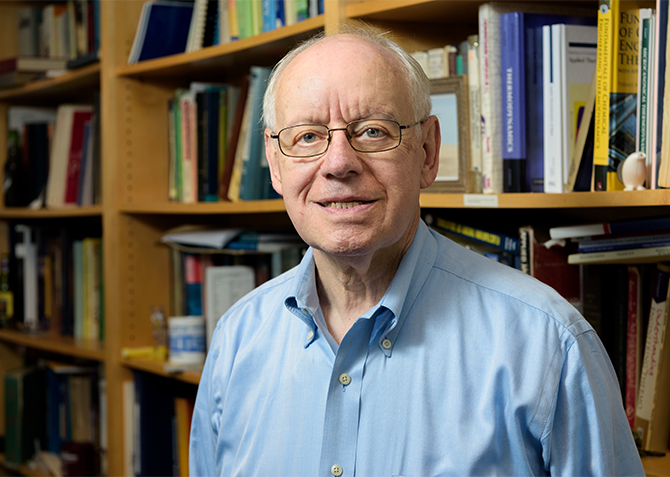 Environmental portrait of Stanley Sandler, the Henry B. duPont Chaired Professor of Chemical and Biomolecular Engineering as well as a photo of him with a collection of text and reference books he's donating to students in developing countries. - (Evan Krape / University of Delaware)