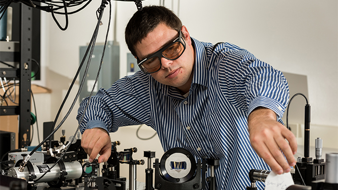 MEEG-Feser_Joseph-Spencer_Lab Associate Professor Joseph Feser, mechanical engineering, working in his Spencer Hall lab with an optical workbench. Feser's work is in "the development of new thin-film thermoelectric device architectures, and experimental characterization of heat transfer on ultrafast timescales/ultra-small length scales."