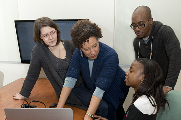 Dr. Gabrielle Foreman and some students discussing her project: colored conventions. Students: Eileen Moscoso, grey sweater & glasses, Clay Colmon & Alyssa Ashley