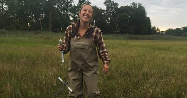IMG_1845.jpg: UD doctoral student Julia Guimond collecting a water sample from the middle of the St. Jones marsh with a syringe and metal sampling pole called a sipper.
