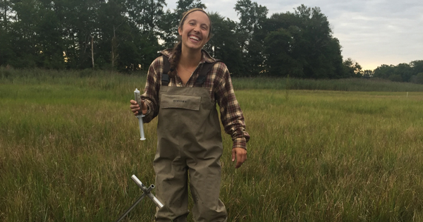 Julia Guimond, UD doctoral student IMG_1845.jpg: UD doctoral student Julia Guimond collecting a water sample from the middle of the St. Jones marsh with a syringe and metal sampling pole called a sipper.
