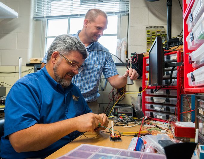Kevin Brinson and David Huntley assembling and testing low-cost sensors at the Center for Environmental Monitoring and Analysis in Pearson Hall. CEMA