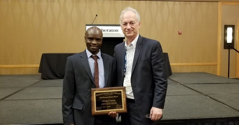 Bruce Stewart-Brown (right), senior vice president of food safety and quality live operations, Perdue Farms, pictured with UD graduate student Michael Balak at the American Association of Avian Pathologists award presentation ceremony in Denver during the American Veterinary Medical Association Convention in July 2018.