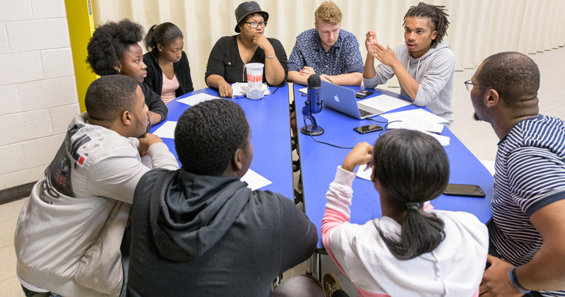 In the next few weeks, UDaily will feature Q&As with 12 of the more than 530 Summer Scholars who participated in research and service-learning projects this summer. In this photo, a team of University of Delaware Summer Scholars meets with teens from Wilmington, Delaware, to learn about their concerns and ideas. UD students on this team include: from left to right, starting with three facing the camera – Samantha Gibbs, Liam Stewart, Christian Mills and Adolphus Fletcher.