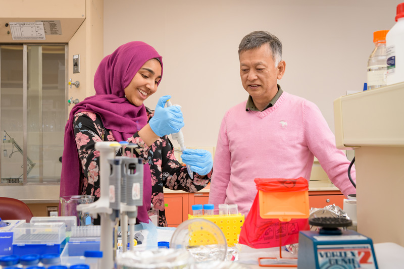 Hira Peracha (left) works in the research lab where her mentor, Dr. Shunji Tomatsu of Nemours/Alfred I. duPont Hospital for Children, studies the rare genetic disorders known as MPS. 
