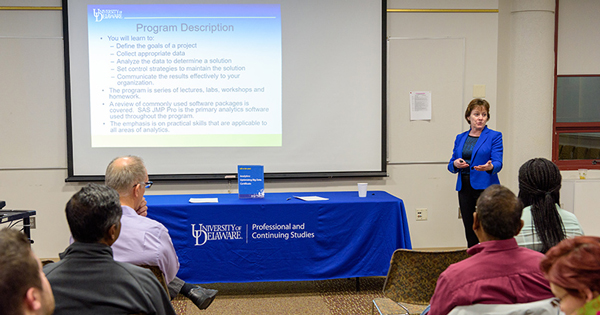 Instructor Carmen Traxler speaks with prospective students about UD’s Analytics