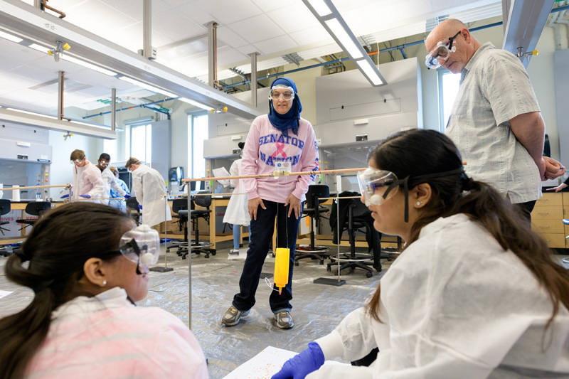 Dover High School teacher Zubia Majeed (center) encouraged students Nadia Sheikh and Fiza Malik (foreground), who are from MOT (Middletown, Odessa and Townsend) Charter High, as they conducted an experiment at the a weeklong science, technology, engineering, arts and math (STEAM) Summer Academy held this summer in the Interdisciplinary Science and Engineering Laboratory (ISE Lab) at the University of Delaware. 