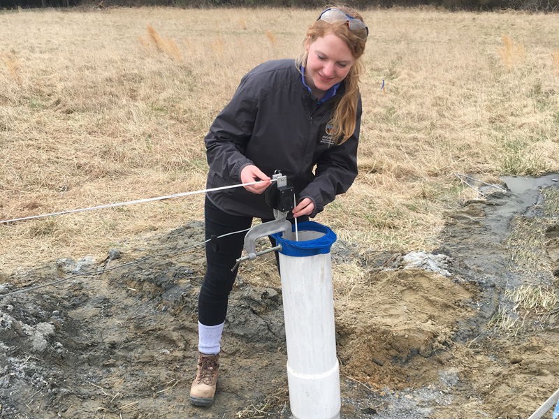UD alumna Sara Albrecht lowers a well camera to monitor a well as part of her duties with the Maryland Department of the Environment.