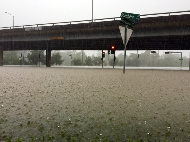 Heavy rain pouring down and flooding a major intersection during Hurricane Harvey.