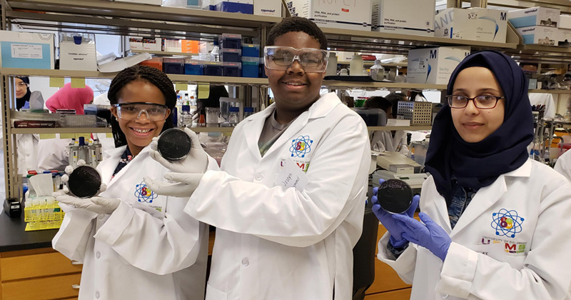 High school students in UD’s Upward Bound program spent several weeks this summer in Prof. Ramona Neunuebel’s lab, getting to know what it’s like to do research and work as a scientist. In this photo are (left to right): Victoria Wiley, Joseph Raymond and Hager Qasim.