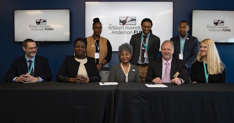 Representatives signing documents