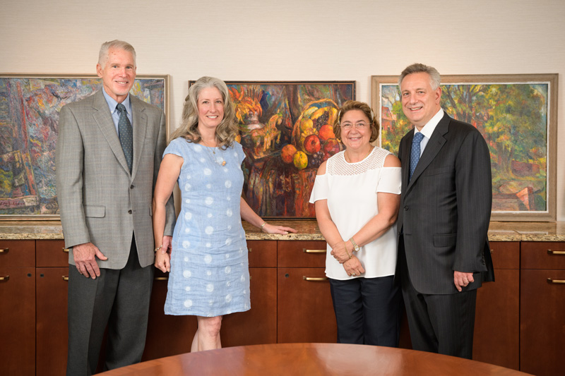 University of Delaware alumnus David Baldt, Sandra Baldt, Eleni Assanis and UD President Dennis Assanis stand in front of newly donated Edward Loper paintings that will now be part of the University’s collections.