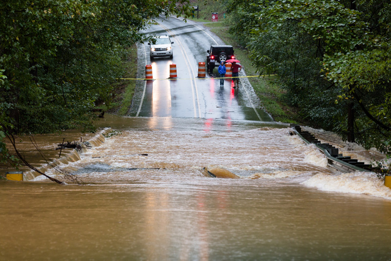 Waxhaw, North Carolina - September 16, 2018: Motorists inspect a Flooded road in North Carolina after Hurricane Florence