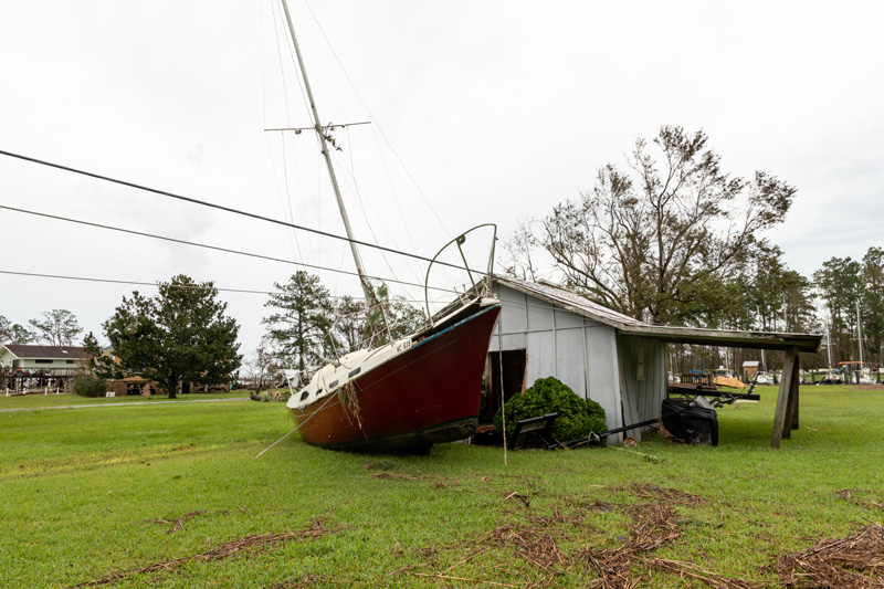 The sailboat and house are next to each other after Hurricane Florence