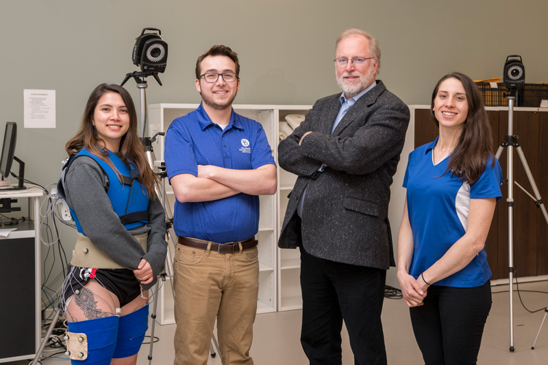 Tom Buchanan, Mechanical Engineering, studies the affect of ACL tears/repairs on later osteoarthritis of the knee.  He works with graduate students Jack Williams (only guy), Kelsey Neal (gray hoodie/blue shirt) and demonstrator Megan Leibowitz. (Releases were obtained on all pictured.)