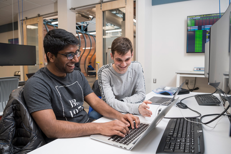 Dr. Andy Novocin teaches students developing and practicing cybersecurity skills to make them more “ethical” hackers in the world of cybersecurity in the iSuite at Evans Hall, Friday, March 22nd, 2019.  Students are: Dan Goodman (gray long sleeve), Vineeth Gutta (black shirt, khakis), Landon JOnes (black jacket), Ryan Geary (green crewneck), Thomas Pisklak (striped t-shirt), Isabel Navarro (red pants, brown blazer), Collin Clark (jean jacket, nose piercing), And Alena Gusakov (red shirt, jeans)  (PHOTO RELEASES WERE OBTAINED ON ALL PICTURED.)