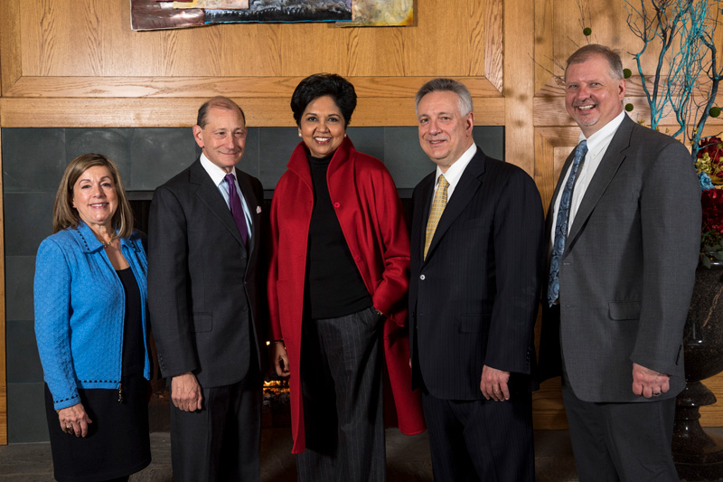 The Weinberg Center breakfast before the event begins with group photos and networking. Group photos taken with President Dennis Assanis, John Pelseko, Myron Steele and Indra Nooyi. 
(Signage was posted around the event.)