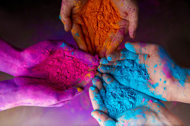 936078128 cropped view of hands with holi powder for Hindu spring festival of colours
