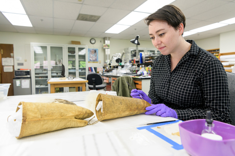 Caitlin Richeson, a graduate student in the Winterthur / University of Delaware Program in Art Conservation program, working to conserve the mittens worn by Matthew Henson during the 1908–09 expedition to the geographic North Pole with Robert Peary. Henson, who served as navigator, craftsman, and was known as Peary's "first man" on the expeditions, was also the first African-American Arctic explorer. - (Evan Krape / University of Delaware)