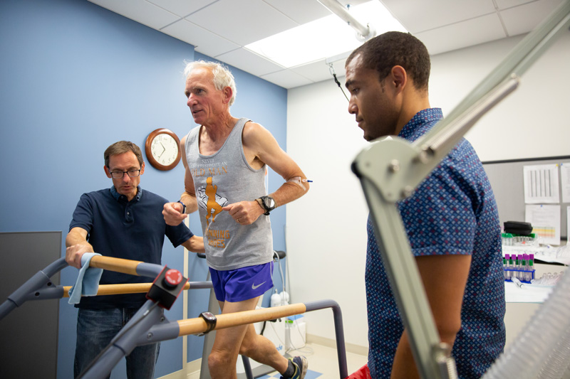 Austin Robinson, Joseph Watso and Bill Farquhar run performance physiology tests on Gene Dykes, a 70-year-old runner who holds records in the marathon and other distances.
They ran several performance tests, including VO2max (maximal aerobic capacity), lactate threshold (how much work he can do before lactate builds up in his blood), running economy (how efficient a runner he is) and body composition (how much fat and lean tissue he has).