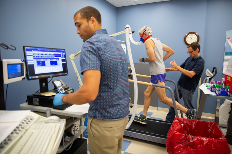 Austin Robinson, Joseph Watso and Bill Farquhar run performance physiology tests on Gene Dykes, a 70-year-old runner who holds records in the marathon and other distances.
They ran several performance tests, including VO2max (maximal aerobic capacity), lactate threshold (how much work he can do before lactate builds up in his blood), running economy (how efficient a runner he is) and body composition (how much fat and lean tissue he has).