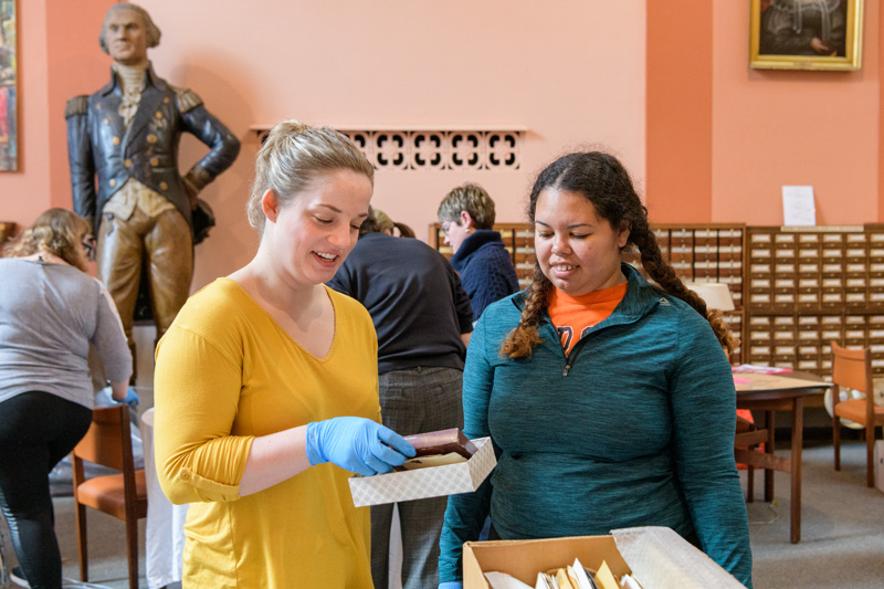 Graduate students from various programs participating in the 2019 Museum Studies "SWAT" program at the Delaware Historical Society Research Library in Wilmington, DE. SWAT is an annual eight-day service project to help small museums and historical centers with their collections while giving students an on-site and hands-on experience towards a Museum Studies certificate. - (Evan Krape / University of Delaware)