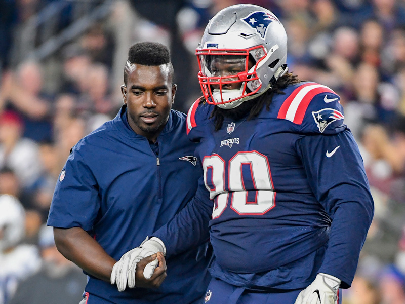 New England Patriots defensive lineman Malcom Brown (90) is assisted off the field by medical personnel during the NFL regular week 5 football game against the Indianapolis Colts on Thursday, Oct. 4, 2018 in Foxboro, MA. The Patriots won 38-24.  (Jim Mahoney via AP)